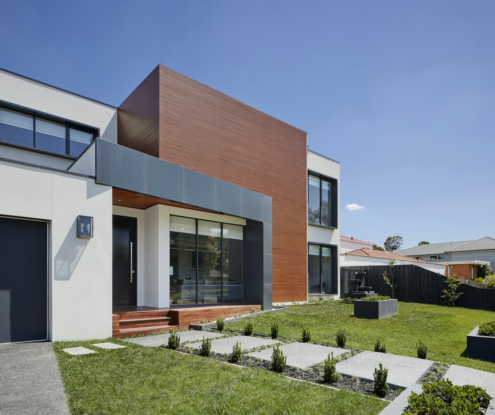 Newly built two-story custom residence with wood and stucco facade